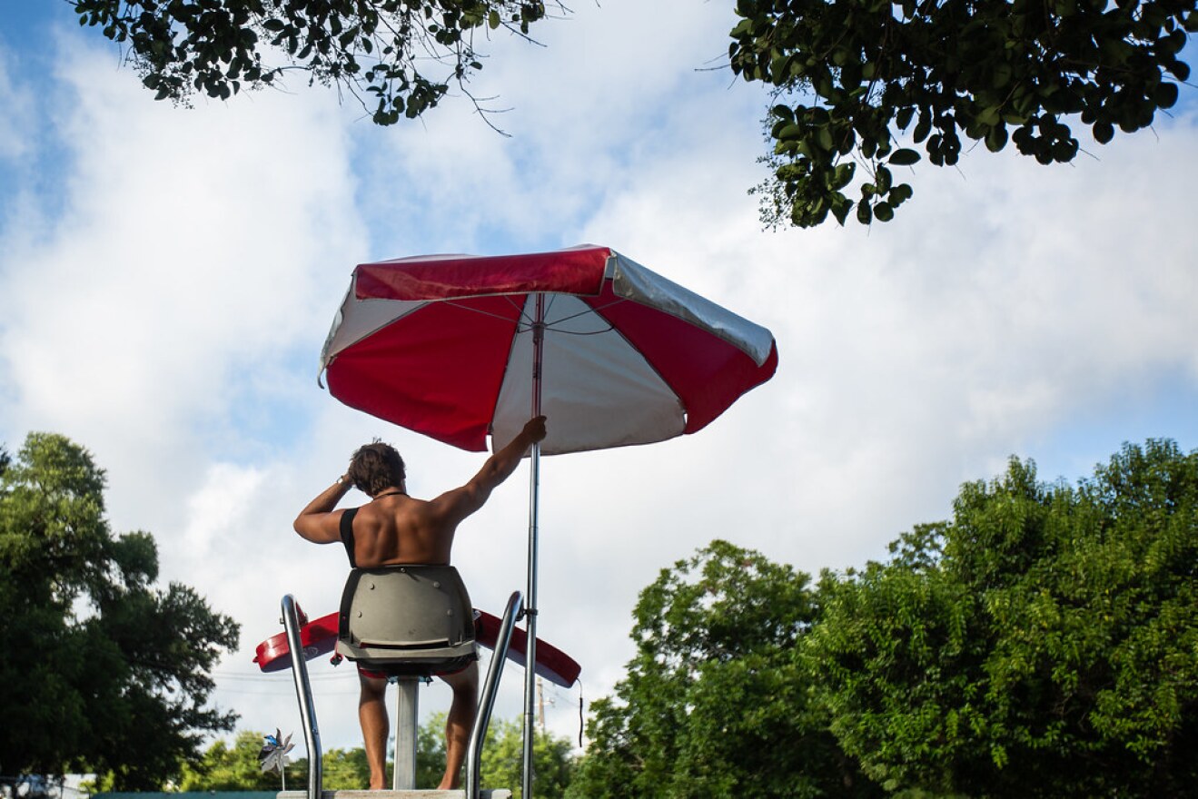 Quinlin Taylor watches swimmers at Big Stacy Pool in South Austin last month. 